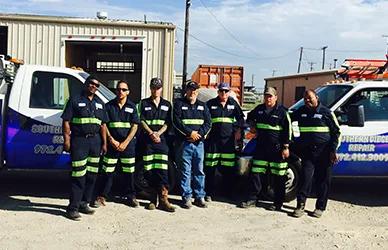 SDR technician team standing beside service trucks